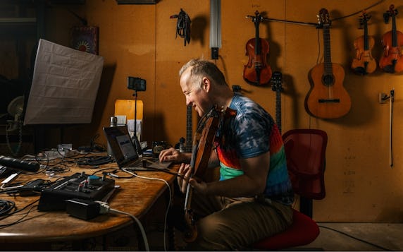 Chris Howes, American violinist, producing songs on his computer