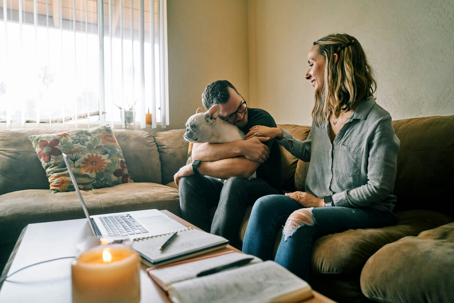 People and dog sitting on couch